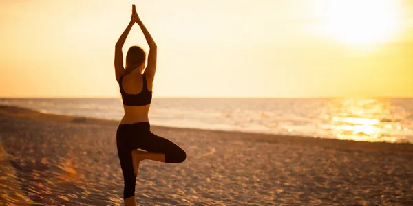 Yoga instructor demonstrating pose at Perfect Ession studio